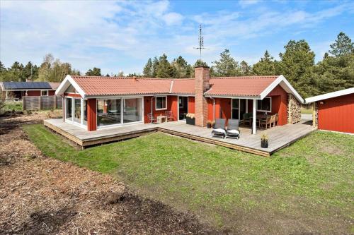 a home with a deck and a house at 0351-Romo-Regnspoven-8 in Mølby