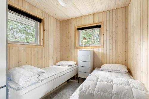 two beds in a room with two windows at 11130-Nykobing-Sj-Vindingsvej-24 in Nykøbing Sjælland