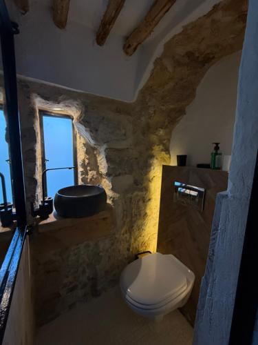 a bathroom with a white toilet and a sink at Casa Dea - bungalow Mykonos in Hammamet Sud