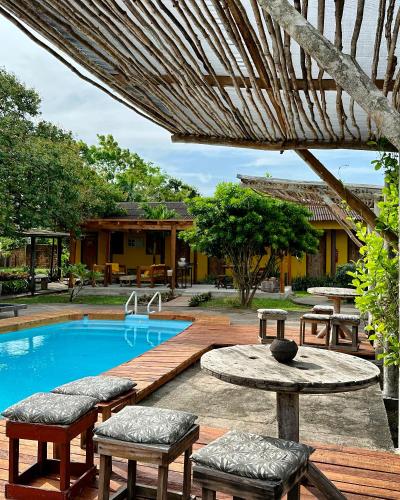 a patio with a pool and tables and chairs at Hotel Urumajó in Augusto Correa