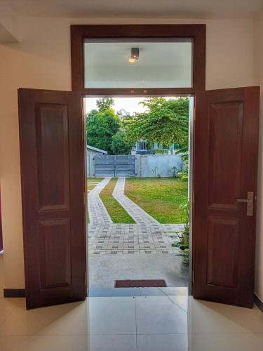 an open door with a view of a yard at Villa Aanya in Katunayake