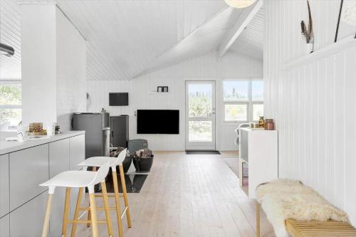 a kitchen with white walls and white floors at BL1598-Blokhus-Raevestien-2 in Blokhus