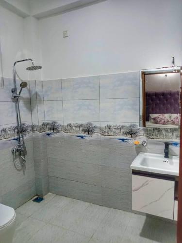 a bathroom with a shower and a sink at Villa Aanya in Katunayake