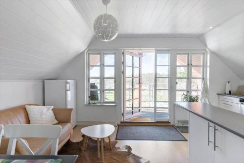 a kitchen and living room with a couch and a table at BL1454-Pandrup-Rodhusvej-215 in Pandrup