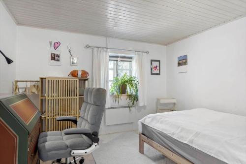 a bedroom with a bed and a chair and a desk at BL1454-Pandrup-Rodhusvej-215 in Pandrup