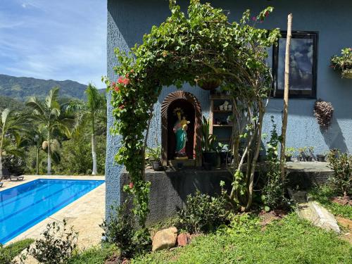 a house with a swimming pool next to a building at Hotel Selva Cristal in San Carlos