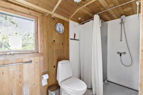 a bathroom with a toilet and a shower and a window at 12274-Sjaellands-Odde-Lyngvang-13 in Tjørneholm