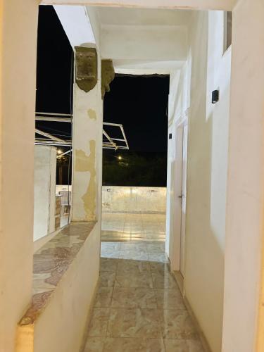 an empty hallway in a building with a view of a room at Farida Pyramids ŌTEL in Cairo