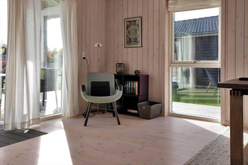 a living room with a chair and a television at 11185-Nykobing-Sj-Lynghaekken-8 in Nykøbing Sjælland