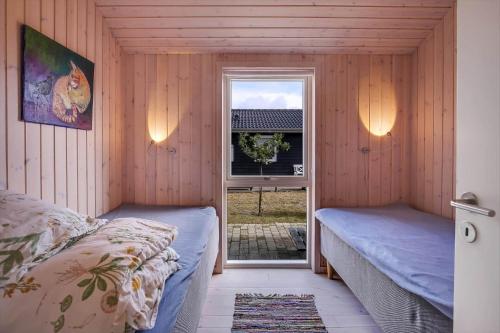 a bedroom with two beds and a window at 11185-Nykobing-Sj-Lynghaekken-8 in Nykøbing Sjælland