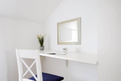 a white desk with a mirror and a chair at 10057-Nykobing-Sj-Bystedvej-10-Hus-29 in Rørvig