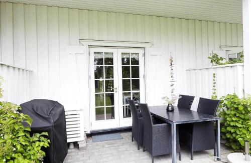 a black table and chairs on a patio at 10057-Nykobing-Sj-Bystedvej-10-Hus-29 in Rørvig