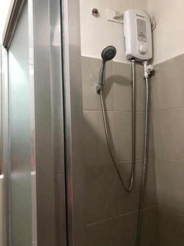 a shower in a bathroom with a shower at 1 BR Taytay Condo WIFI Cignal Netflix Pool Patio in Taytay