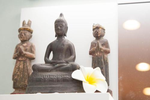 a statue of two women and a flower on a shelf at Akasaka-no Sato (Female Only) in Tokyo