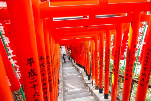 a row of orange torii gates in a building at Akasaka-no Sato (Female Only) in Tokyo