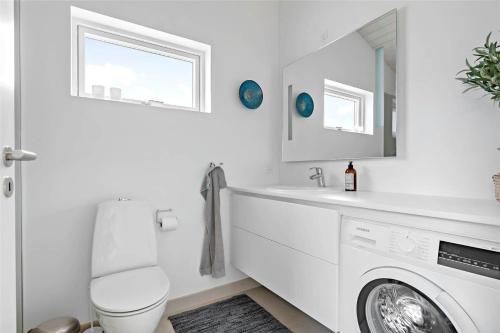 a white bathroom with a toilet and a sink at 11197-Nykobing-Sj-Lynghaekken-48 in Nykøbing Sjælland