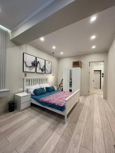 a bedroom with a bed in a room at Studio apartment in Dushanbe