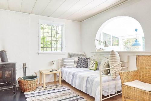 a living room with a bed and a fireplace at 11817-Nykobing-Sj-Solystgardsvej-16 in Nyrup