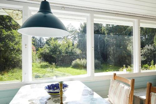 a dining room with a table and a large window at 11817-Nykobing-Sj-Solystgardsvej-16 in Nyrup