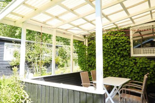 a pergola on a patio with a table and chairs at 11817-Nykobing-Sj-Solystgardsvej-16 in Nyrup