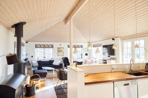 a kitchen and a living room with a couch at 10014-1-Rorvig-Troldevaenget-5 in Rørvig