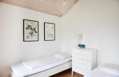 a white bedroom with two beds and a dresser at 10014-1-Rorvig-Troldevaenget-5 in Rørvig