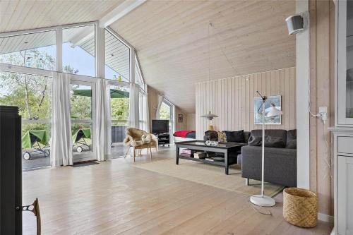 a living room with a couch and a table at 11174-Nykobing-Sj-Pilehaekken-6 in Nykøbing Sjælland