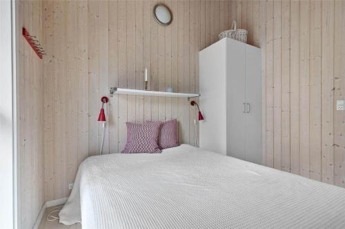 a bedroom with a white bed with purple pillows at 11174-Nykobing-Sj-Pilehaekken-6 in Nykøbing Sjælland
