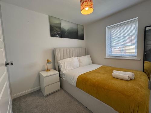 a small bedroom with a bed and a window at Alvea Living in Bushbury