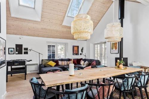 a living room with a wooden table and chairs at 16610-Farevejle-Mejsevaenget-26 in Fårevejle