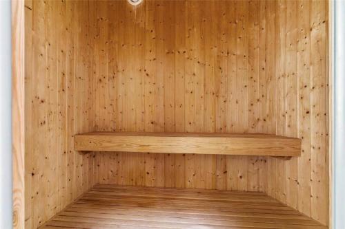 a wooden sauna with a wooden shelf in it at 16610-Farevejle-Mejsevaenget-26 in Fårevejle