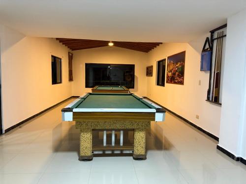 a pool table in a room with a tv at Hotel Selva Cristal in San Carlos