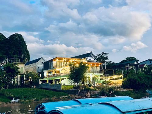 a building with a car parked in front of it at Horizon Homestay in Phong Nha