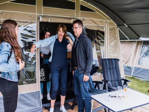 a group of people standing inside of a tent at Tent Lodge near Echternach Nature Park in Echternacherbrück
