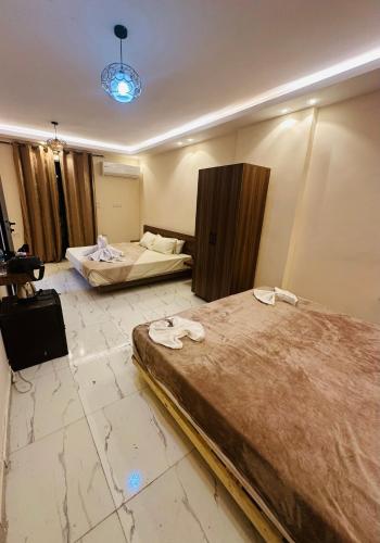a hotel room with two beds in a room at Pyramids sun set view in Cairo