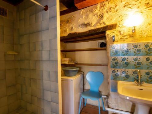 a bathroom with a toilet and a sink and a blue stool at Gîte familial avec WiFi près de Brantôme - FR-1-616-102 in Saint-Front-la-Rivière