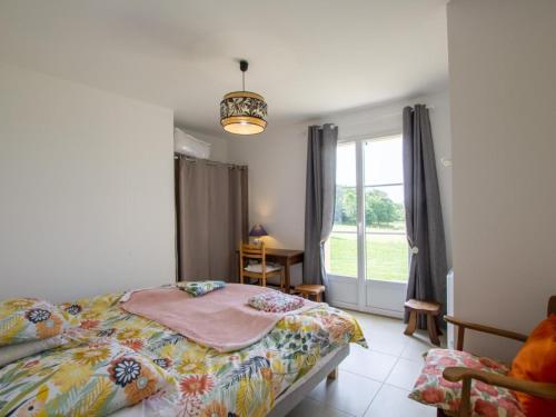 a bedroom with a bed and a window at Maison familiale avec terrasse, clim et jeux enfants en Périgord - FR-1-616-334 in Sainte-Orse