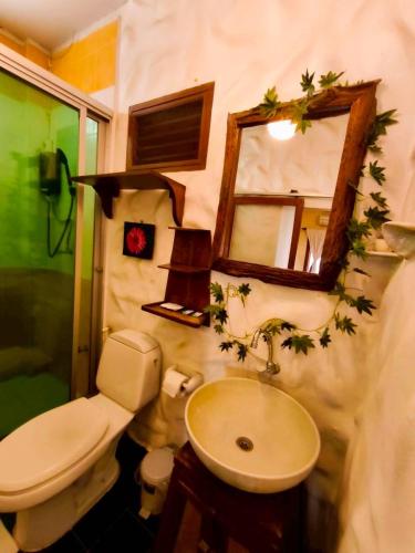 a bathroom with a sink and a toilet and a mirror at Plumeriahome near Chiangmai Airport in Chiang Mai