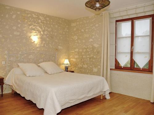 a bedroom with a white bed and a window at Authentique Maison de Vigneron XIXe au Coeur du Val de Loire, 4 Chambres, Parking, Jardin - FR-1-381-126 in Cangey