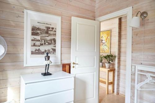 a white door in a room with wooden walls at 10061-1-Rorvig-Lindegardsvaenget-5 in Rørvig