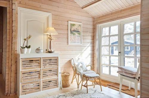 a room with a dresser and a chair and a window at 10061-1-Rorvig-Lindegardsvaenget-5 in Rørvig