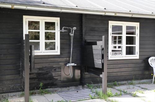 a shower on the side of a house with two windows at 10061-1-Rorvig-Lindegardsvaenget-5 in Rørvig