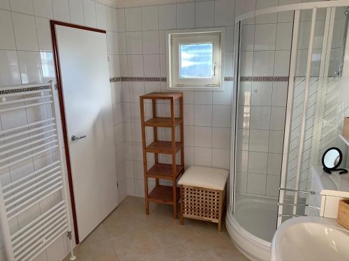 a bathroom with a shower and a toilet and a sink at Holiday home on the recreational lake in Lathum