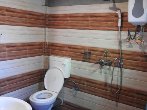 a bathroom with a toilet and a shower at EHI Homestay Kurseong in Kurseong
