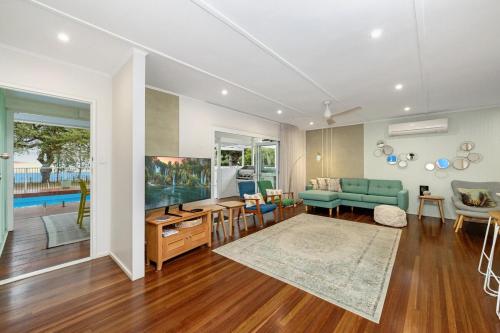 a living room with a couch and a table at Welcome to The Island House in Arcadia