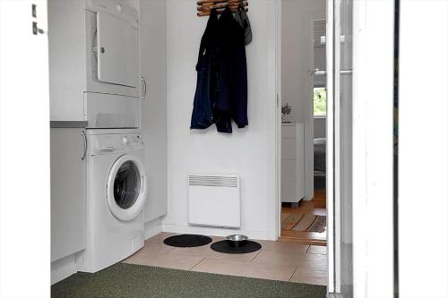 a white laundry room with a washer and dryer at 14242-Vig-Maglehojvej-6 in Vig
