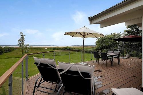 a deck with a table and an umbrella at 14242-Vig-Maglehojvej-6 in Vig