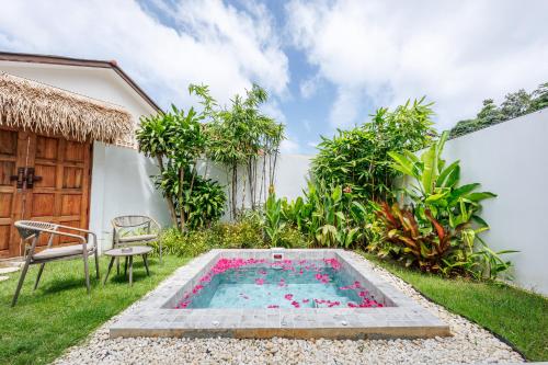 a swimming pool in the backyard of a house at Baan Saint-Tropez Seaview Villas Kata Beach in Kata Beach