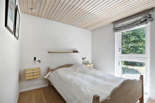 a bedroom with a bed and a window at 11153-Nykobing-Sj-Lyngvejen-27 in Nykøbing Sjælland