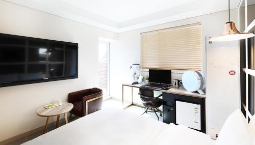 a room with a desk and a computer in it at 알마비즈니스호텔 in Jincheon